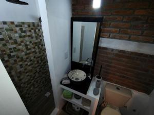 a bathroom with a shower and a toilet and a mirror at Vinoteca cerro in Piriápolis