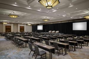 a conference room with tables and chairs and a screen at Denver Marriott South at Park Meadows in Lone Tree +51 photos