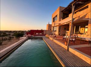 a swimming pool in the middle of a house at Villa Lala Argana in Essaouira