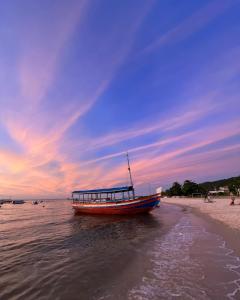 a boat in the water on the beach at San Sebastian Taipu de Fora in Marau