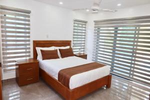 a bedroom with a large bed and some windows at Villa Plasencia! in El Tetero +31 photos