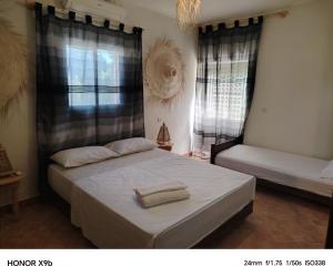 a bedroom with a bed with a towel on it at Ferme d'hôtes Aghbalou in Sefrou +37 photos