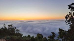 a view from the top of a mountain of clouds at Ko Glamping in Valdivia
