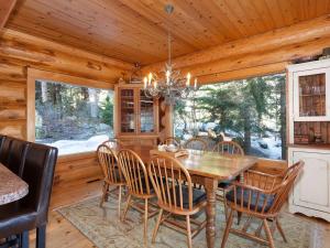 uma sala de jantar com mesa e cadeiras de madeira em Heron Chalet by Outpost Whistler em Whistler