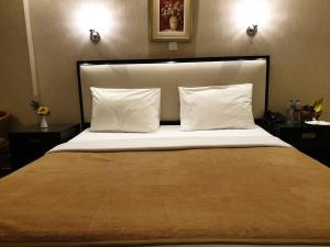a bedroom with a large bed with white pillows at Palm Beach Hotel in Dubai +23 photos