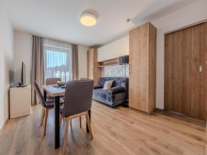 a living room with a table and a couch at Cosy apartment near Jochberg Centre in Jochberg