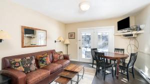 a living room with a couch and a table at Viking Lodge 117 by AvantStay Ski Home Near Town Park Downtown in Telluride