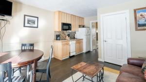 a living room with a table and a kitchen at Viking Lodge 117 by AvantStay Ski Home Near Town Park Downtown in Telluride