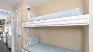 two bunk beds in a room with a chair at Viking Lodge 117 by AvantStay Ski Home Near Town Park Downtown in Telluride