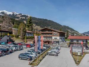 a parking lot with cars parked in front of a building at Apartment with ski-storage, parking in Jochberg +12 photos