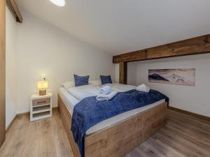 a bedroom with a large bed with a blue blanket at Apartment in Jochberg on ski-slope in Jochberg +15 photos