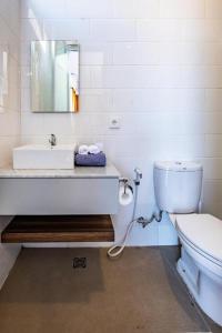 ein weißes Badezimmer mit Waschbecken und Toilette in der Unterkunft 2BR Sun Flower Home in Uluwatu