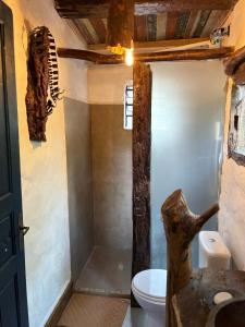 a bathroom with a white toilet and a sink at Casa Ar Fresco in Sapiranga