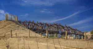 a large wooden structure on top of a hill at Tiny Beach Cottage - New Vennepark Wenduine in De Haan
