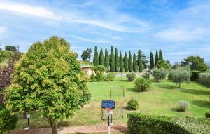 a park with a basketball hoop and a tree at Seranna 4 in Papiano