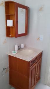 a bathroom with a sink and a mirror at Praia, Laser, Comércio in Praia Grande +34 photos