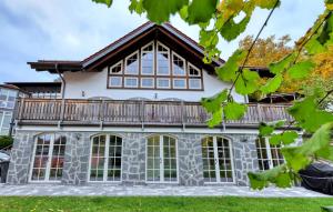 a house with a balcony on top of it at Amazing Apartment In Südharz With Sauna in Stolberg i. Harz