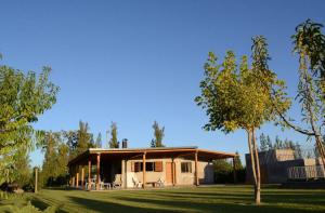 a small house in a yard with a tree at Casa Isolina in Ciudad Lujan de Cuyo