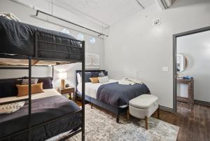 a bedroom with two bunk beds and a mirror at Urban Luxe Loft in Dallas