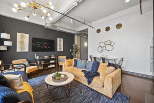 a living room with a couch and a table at Urban Luxe Loft in Dallas