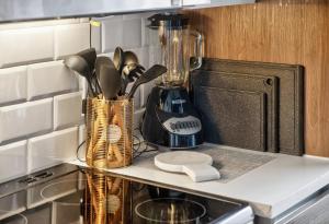 a kitchen counter with a blender on a shelf at Urban Luxe Loft in Dallas +40 photos