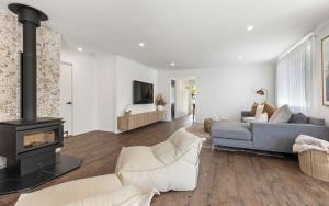 a living room with a couch and a fireplace at 10 min walk to beach and cafés, Quiet area, Bikes in Byron Bay