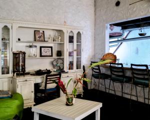 a room with a table and chairs and a kitchen at Hostel Posada 1914 in Panama City