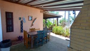 a patio with a table and chairs and a building at Ninho da Águia - Chalés in Poços de Caldas