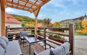 a patio with chairs and a table on a deck at Beautiful Apartment In Südharz With Wifi in Stolberg i. Harz