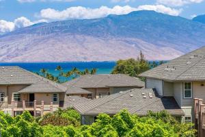 a row of houses with a mountain in the background at Kihei Alii Kai C405 · KAK C405 Updated 2BD Condo Across Beach w in Kihei