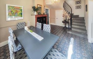 a dining room with a blue table and chairs at Nice Home In Saint-Chinian With Wifi in Saint-Chinian