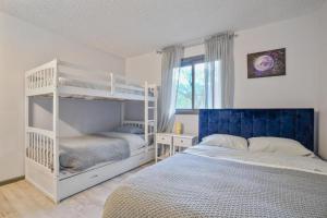 a bedroom with two bunk beds and a window at 4BD Cabin in the Poconos Near Lake with Hot Tub, Sauna, Game Room and Movie Room in East Stroudsburg +41 photos