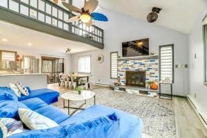 a living room with a blue couch and a fireplace at 4BD Cabin in the Poconos Near Lake with Hot Tub, Sauna, Game Room and Movie Room in East Stroudsburg