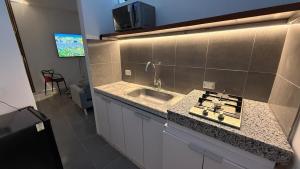 a kitchen with a sink and a counter top at Maison Áurea Loft in Cali +8 photos