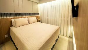 Ένα ή περισσότερα κρεβάτια σε δωμάτιο στο O mais novo e aconchegante da cidade