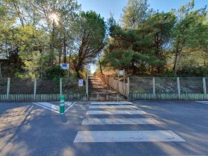 an empty parking lot with a fence and stairs at Maisonnette confortable proche plage, 4 pers, parking privé - FR-1-476-203 in La Faute-sur-Mer