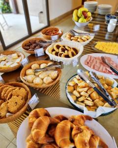 a table topped with baskets of different types of food at Hotel Blumig in Villa General Belgrano