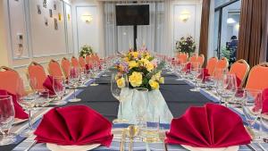 a long table with red napkins and flowers on it at Phoenix Villas FLC Ha Long in Ha Long +87 photos