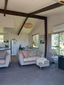 a living room with a couch and a table at Turanga Heights in Gisborne