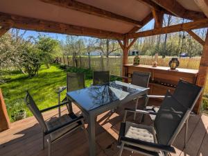 a patio with a table and chairs on a deck at Chambre d'Hôtes Charmante à Montargis - FR-1-590-573 in Montargis