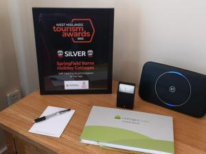 a desk with a cd and a computer on it at The Dairy - Uk10957 in Burlton