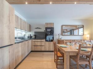 a kitchen and dining room with a table and chairs at Appartement skis aux pieds avec 8 couchages à l'Alpe d'Huez - FR-1-645-96 in L'Alpe-d'Huez
