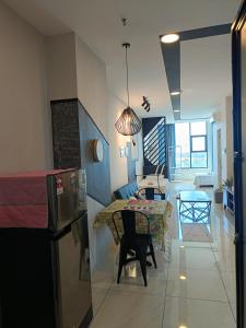 a kitchen and living room with a table and chairs at Modern Home surrounded with many Amenities in Donggongon