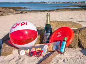 a bottle of champagne and a ball on the beach at Spacieux studio terrasse, mer à 700m commerces, parking privé, Wi-Fi inclu - FR-1-349-116 in Larmor-Plage