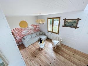 a living room with a couch and a chair at Maison de vacances à 20m de la plage, jardin clos, Wi-Fi, idéale famille - FR-1-361-163 in Jullouville-les-Pins