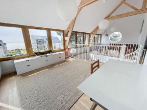 a room with a table and some windows at Maison de vacances à 20m de la plage, jardin clos, Wi-Fi, idéale famille - FR-1-361-163 in Jullouville-les-Pins