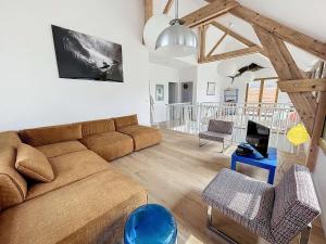 a living room with a brown couch and chairs at Maison de vacances à 20m de la plage, jardin clos, Wi-Fi, idéale famille - FR-1-361-163 in Jullouville-les-Pins