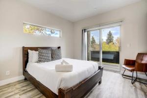a bedroom with a large bed and a window at 4BD Home w Rooftop Patio Fire Pit & Mountain Views in Colorado Springs