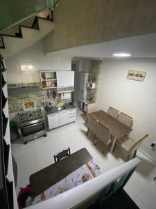 a kitchen with a table and a dining room at Casa para COP30 em Belém- in Belém +5 photos