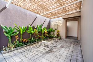 a courtyard with plants in a building at Villa Domus A1 in Sanur